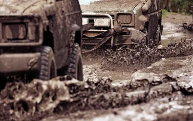 Off-road vehicle crossing through the mud